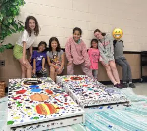 Kids painted corn hole boards for CRI